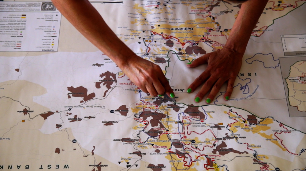 The Wounded Maps (2009-2015). Cutting OCHA maps in the studio Cutting OCHA maps