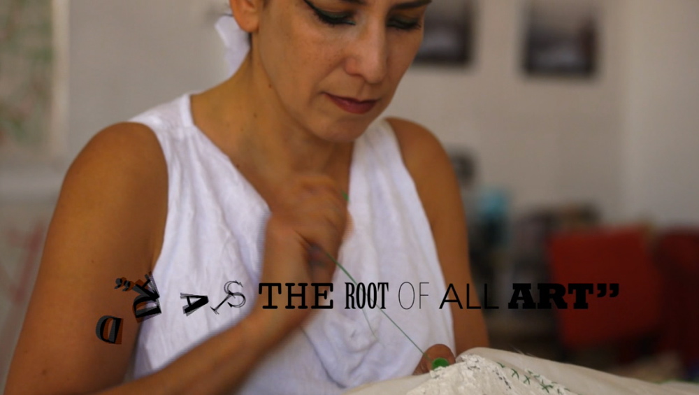 Sewing 'Jerusalem Wounded Map' in the studio, sentence from Dada Messe Berlin 1920, still from video Dada-Jerusalem 004