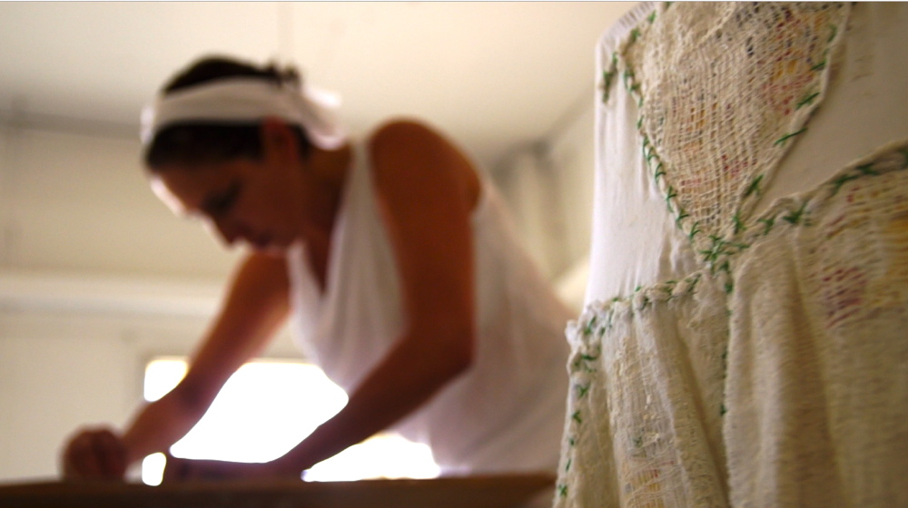 In the studio, in the foreground the dress made of fragments of maps, bandages and green threads, from the video by David Atsmi Dada-Jerusalem 017