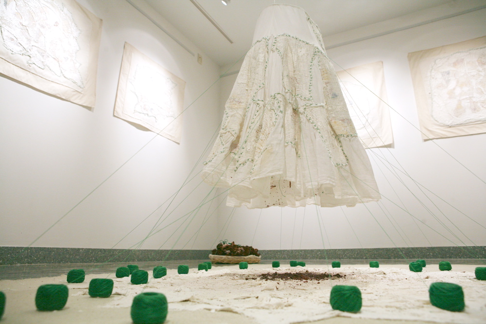 Dressed Land (2012) installation at The Women Artists Series Galleries, Douglass Library, Rutgers University, New Brunswick, New Jersey. Fabric, closure maps, gauzes, green spools, plaster, wax, pigment and earth Dressed Land 02