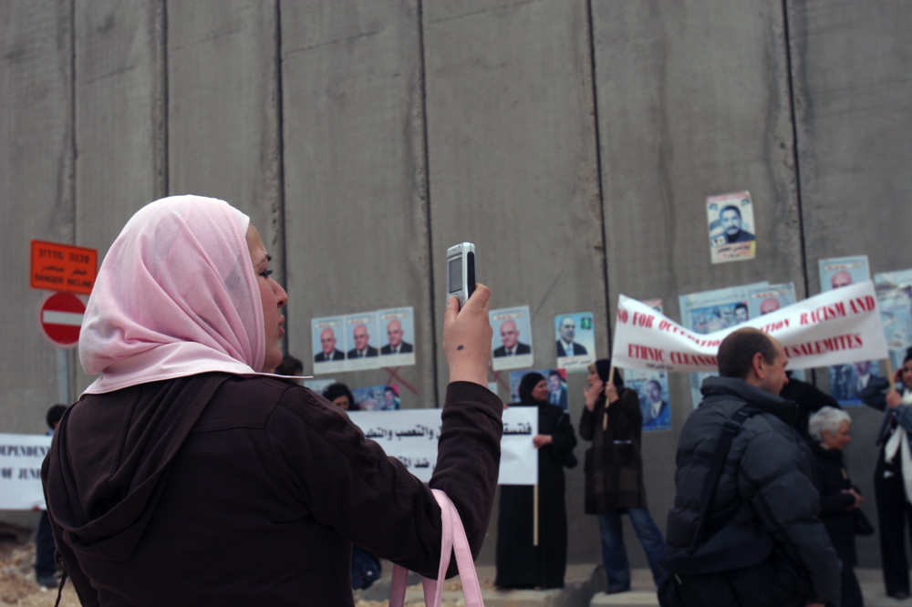 Palestinian woman photographing during a women demonstration of Palestinian and Israeli women against the wall, Kalandiya February 2006 Palestinian woman photographing demonstration in Kalandia, Feb 09 06, 04 jpg.